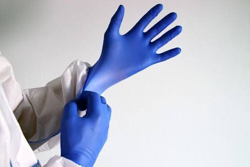 A woman wearing blue examination Gloves